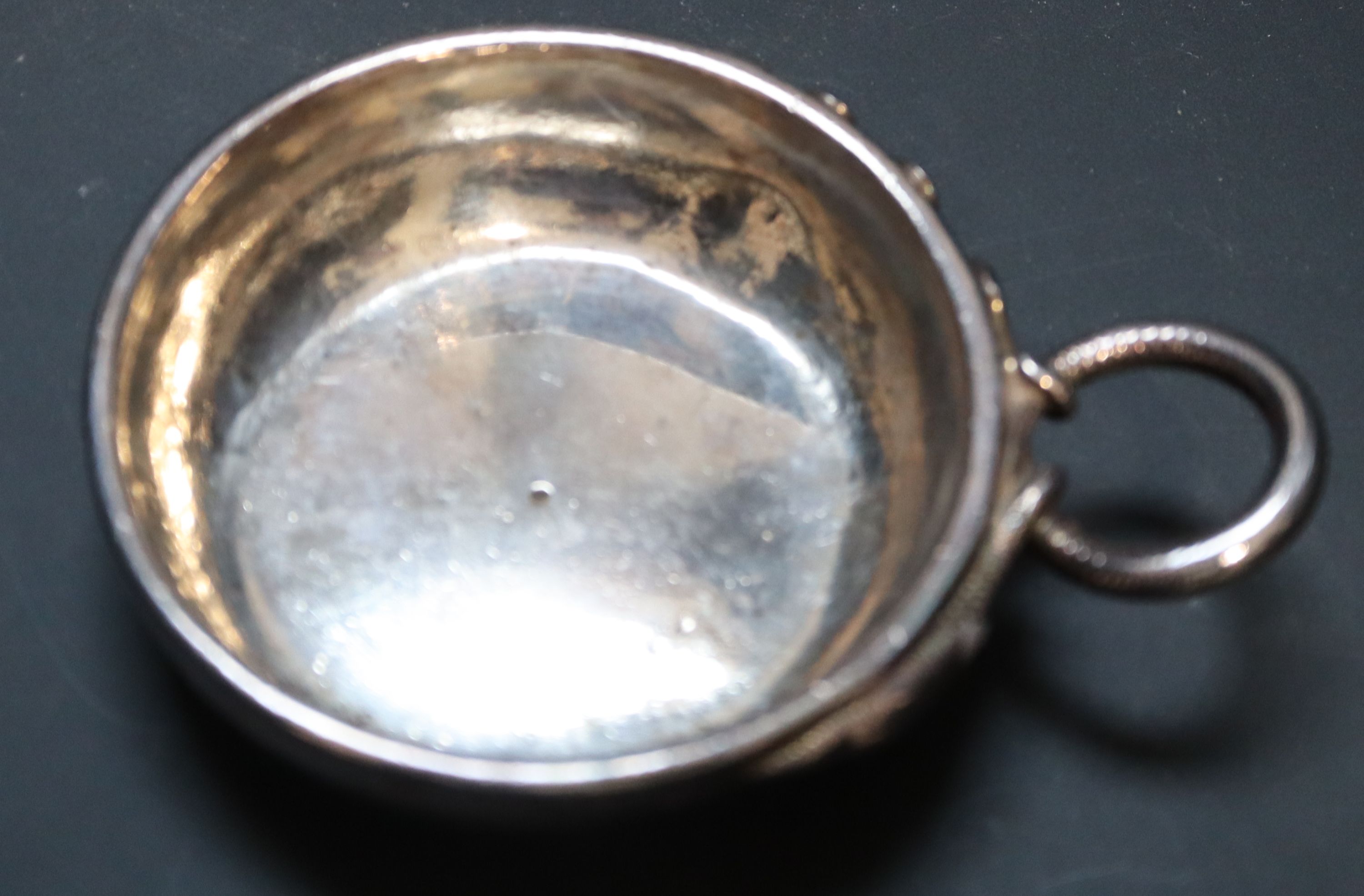 A late 18th century French white metal wine taster, diameter 7.6cm, 4oz.
